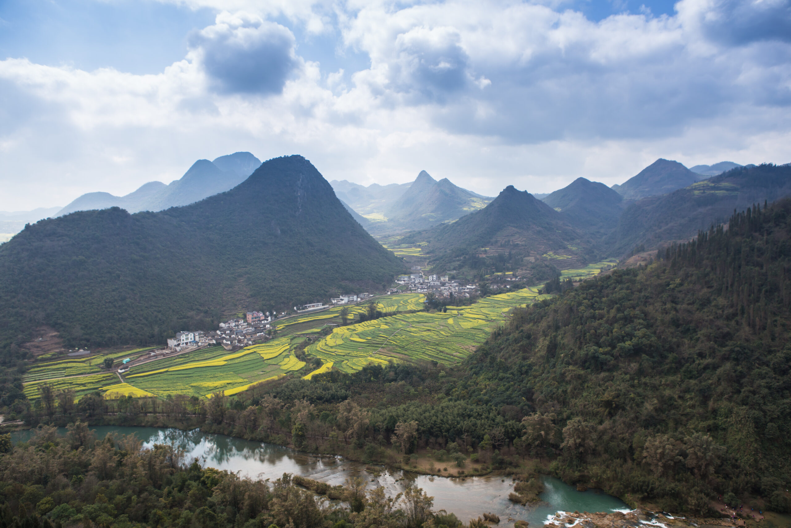 Spring fresh landscape of colorful fields, sunrise sky and beautiful hills valley